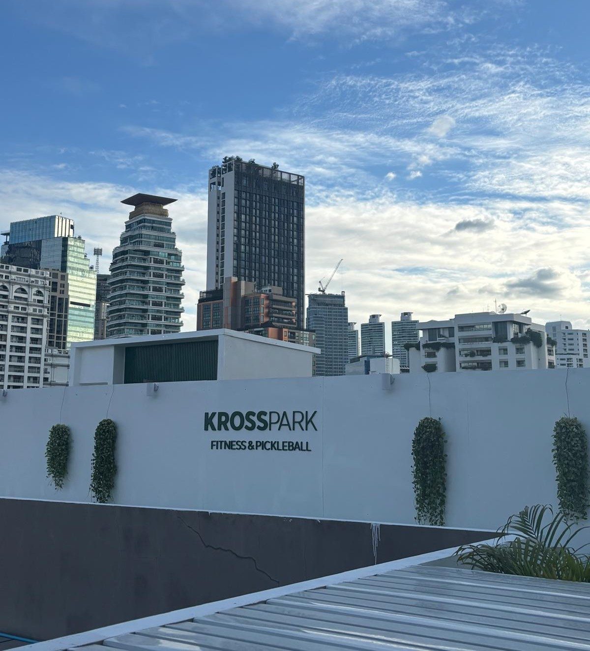 KROSS PARK sign against the Bangkok skyline
